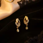 Classic Gold Finish Earrings with Crystal Detailing & Red Stone - Image 3